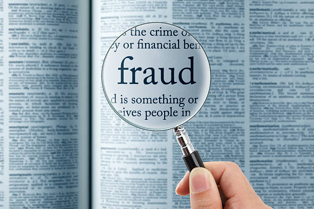 Magnifying glass on the"fraud" in dictionary
